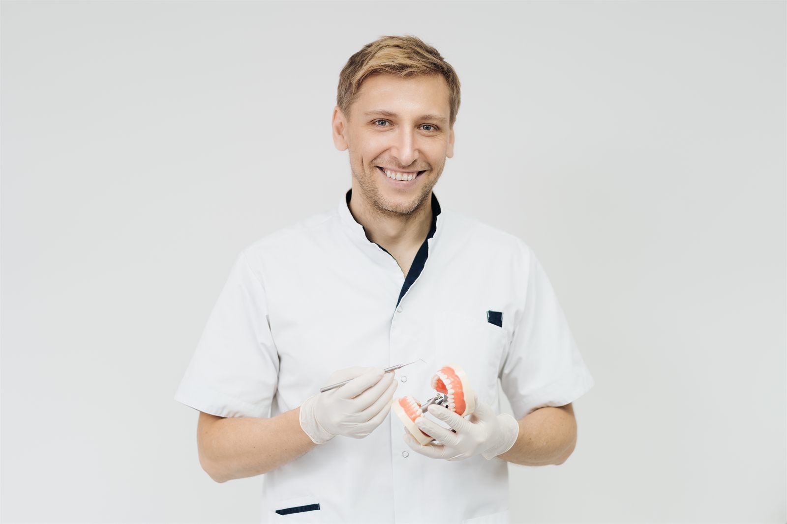 Dental professional explaining oral health with a jaw model